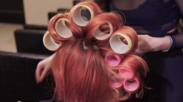 Closeup of red hair during hair dressing with curler. — Stock Video