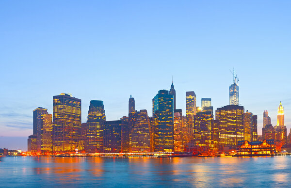 New York City, USA, skyline panorama of downtown Manhattan business buildings at sunset