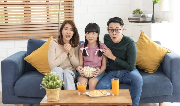 Excited Asian Family Eating Popcorn Watching Together Sofa Home Living — стокове фото