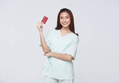 Happy asian woman patient showing credit card isolated on white background. Insurance allowance and charge indemnification concept.