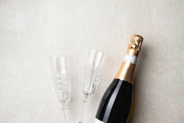 Şampanya Sevgililer Günü 'nün, doğum gününün, düğünlerin sembolüdür. Şampanya şişesi ve arka planda iki bardak, üst manzara.