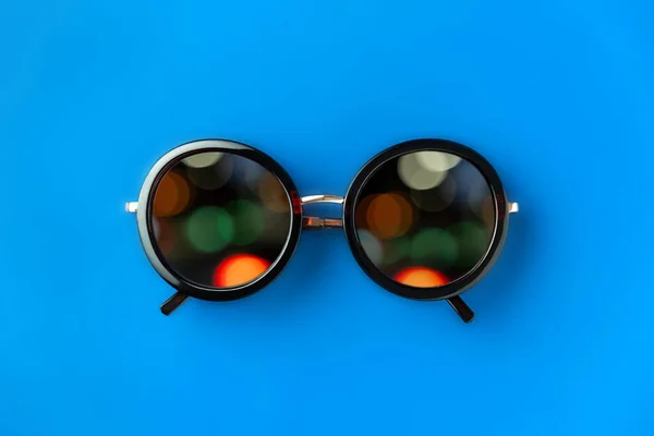 Minimalist Composition Sunglasses Multi Colored Bokeh Lenses Blue Background Close — Stock Photo, Image