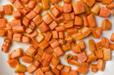 Havuçlar zeytinyağında tavada kızartılıyor, makro shot.