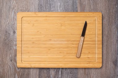 Knife on an empty kitchen board, kitchen background