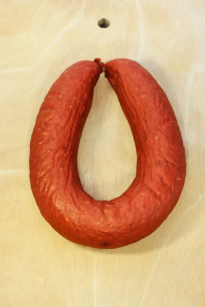 Krakow smoked sausage on wood board — Stock Photo, Image
