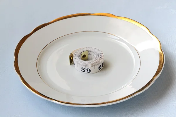 Roll of centimeter on chinaware — Stock Photo, Image
