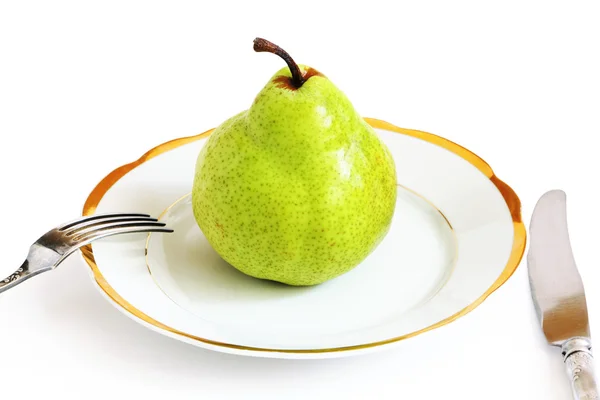 Pera verde en un plato blanco —  Fotos de Stock