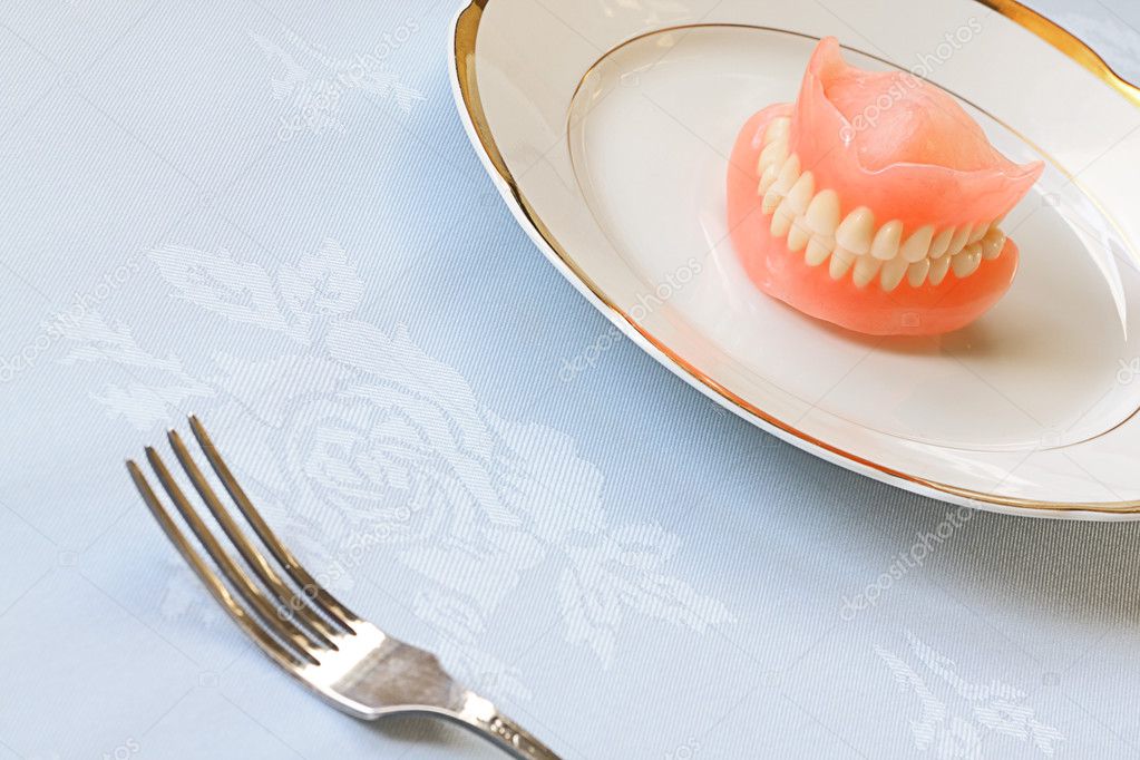 False teeth on white plate