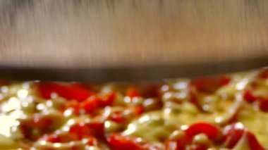 Cook pizza with pepper and cheese in a pan. Steam from cooked food. Fast breakfast. Street food fast.