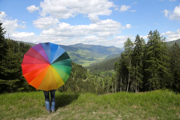 Rainbow umbrella at the Alps — Stock Photo, Image