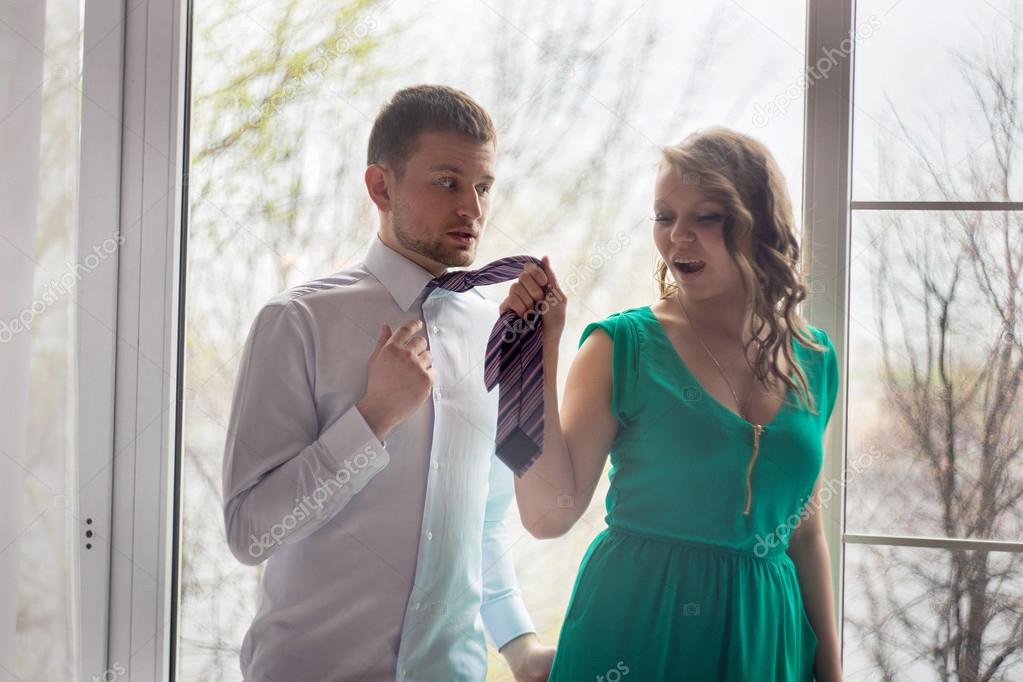 Woman leading a man by his tie — Stock Photo © Leukocheat 25834141