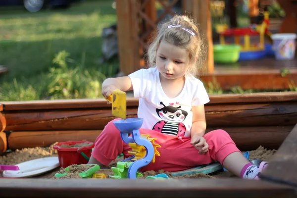 Girl in sandbox — Stock Photo, Image