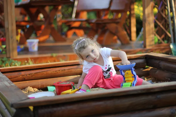 Girl in sandbox — Stock Photo, Image