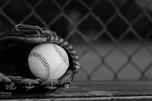 Old retro black and white baseball background with vintage ball and glove