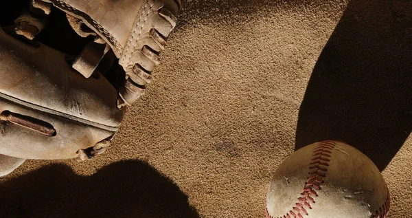 baseball ball and glove on a vintage background