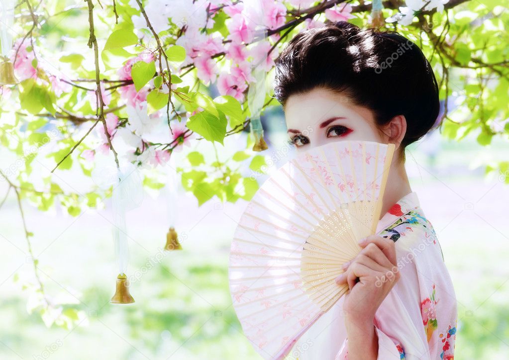 Geisha with fan in the garden