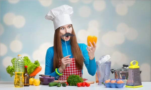 Funny portrait of a woman in chef's hat with paper moustache — Stock Photo, Image