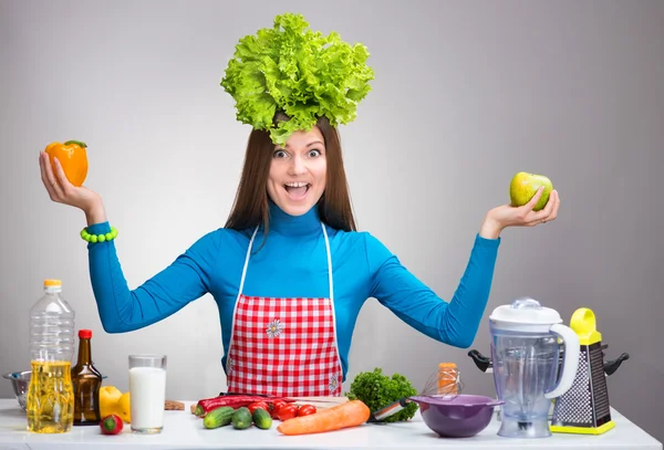 Funny portrait of a woman with the salad on her head