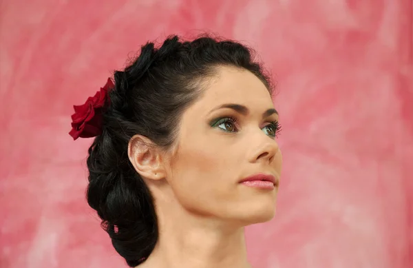 Portrait of a brunette woman on pink background — Stock Photo, Image