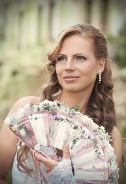 Bride with a fan — Stock Photo, Image