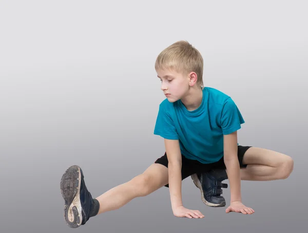 Sportive boy stretching his leg — Stock Photo, Image