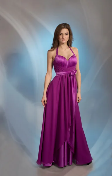 Beautiful girl posing in plum violet evening dress — Stock Photo, Image