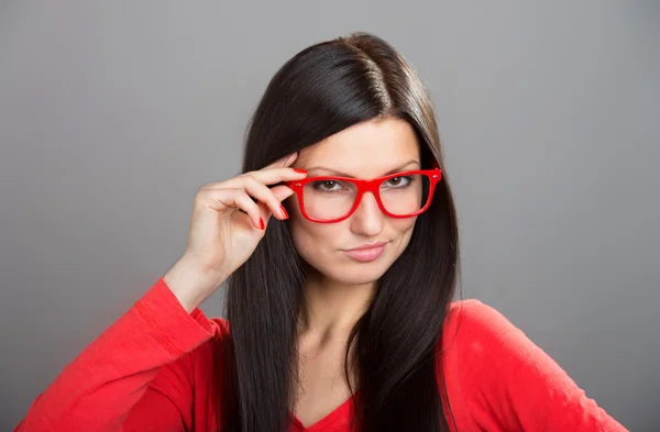 Girl looking over glasses — Stock Photo, Image