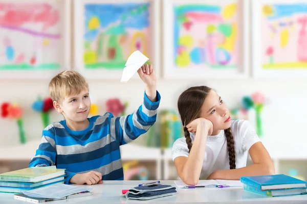 Children sitting by the table — Stock Photo, Image