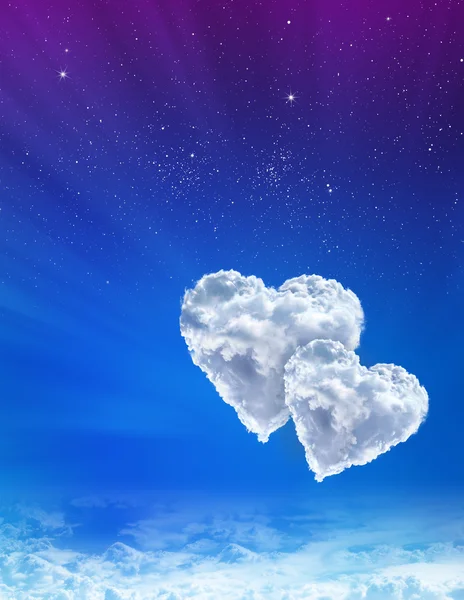 Hearts in clouds against a blue spacу sky — Stock Photo, Image