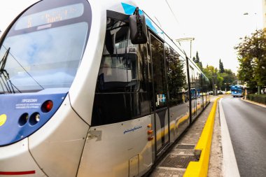 Atina, Yunanistan - 22 Kasım 2021 Coronavirus salgını sırasında Atina sokaklarından geçen yolcular için modern elektrikli tramvay, maske takmak zorunludur