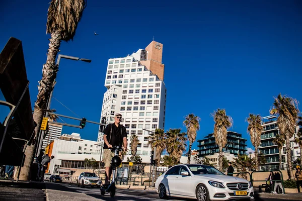 Tel Aviv, İsrail - 11 Şubat 2022 Tel Aviv sokaklarında elektrikli scooter kullanan insanlar, küçük bir iç yanmalı motorlar ve merkezde bir güverte ile çalışıyorlar.