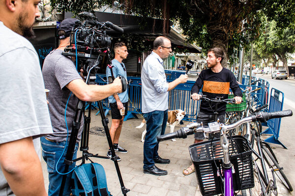 Tel Aviv, Israel - April 08, 2022 Following the Palestinian terrorist attack at the Ilka Bar on Dizengoff Street, journalists reporting the events of last night