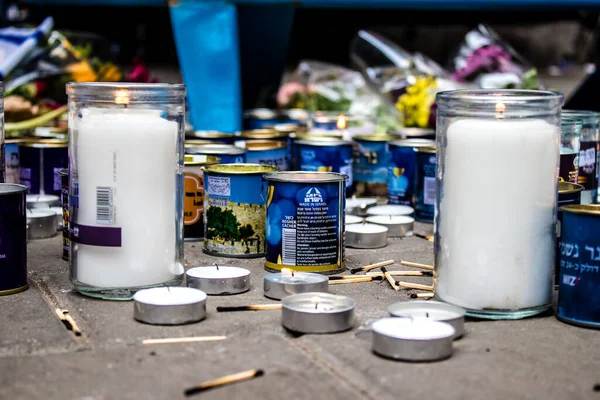 Tel Aviv, İsrail - 8 Nisan 2022 Dizengoff Caddesi 'ndeki Ilka Bar' a düzenlenen terörist saldırının ardından insanlar saldırının gerçekleştiği yere mum ve çiçek bırakmak için geliyorlar.