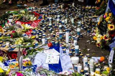 Tel Aviv, İsrail - 8 Nisan 2022 Dizengoff Caddesi 'ndeki Ilka Bar' a düzenlenen terörist saldırının ardından insanlar saldırının gerçekleştiği yere mum ve çiçek bırakmak için geliyorlar.