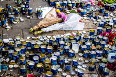 Tel Aviv, İsrail - 10 Nisan 2022 Dizengoff Caddesi 'ndeki Ilka Bar' a düzenlenen terörist saldırının ardından insanlar saldırının gerçekleştiği yere mum ve çiçek bırakmak için geliyorlar.