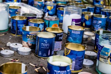 Tel Aviv, İsrail - 10 Nisan 2022 Dizengoff Caddesi 'ndeki Ilka Bar' a düzenlenen terörist saldırının ardından insanlar saldırının gerçekleştiği yere mum ve çiçek bırakmak için geliyorlar.