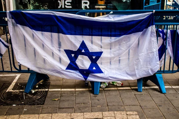 Tel Aviv, İsrail - 10 Nisan 2022 Dizengoff Caddesi 'ndeki Ilka Bar' a düzenlenen terörist saldırının ardından insanlar saldırının gerçekleştiği yere mum ve çiçek bırakmak için geliyorlar.