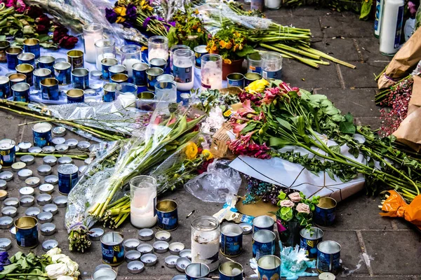 Tel Aviv, İsrail - 10 Nisan 2022 Dizengoff Caddesi 'ndeki Ilka Bar' a düzenlenen terörist saldırının ardından insanlar saldırının gerçekleştiği yere mum ve çiçek bırakmak için geliyorlar.