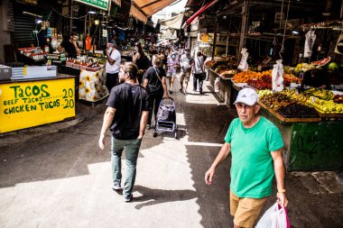 Tel Aviv, İsrail - 18 Nisan 2022 Taze sebze, meyve, zeytin, baharat, erzak, yiyecek ve içecekler Tel Aviv 'deki en ünlü pazarlardan Shuk HaCarmel' de satılıyor.