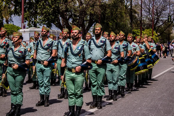 Seville, İspanya - 01 Mayıs 2022 İspanyol Lejyonu 'ndan profesyonel askerlerin geçidi, İspanyol Ordusu' nun bu askeri birliği Feria 'nın fırlatılması için Seville sokaklarında geçit töreni düzenliyor.