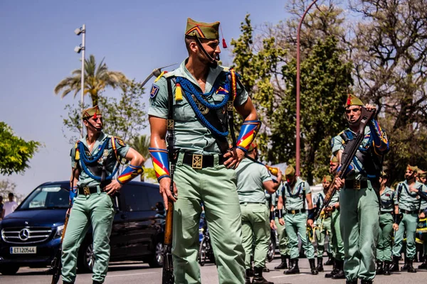 Seville, İspanya - 01 Mayıs 2022 İspanyol Lejyonu 'ndan profesyonel askerlerin geçidi, İspanyol Ordusu' nun bu askeri birliği Feria 'nın fırlatılması için Seville sokaklarında geçit töreni düzenliyor.