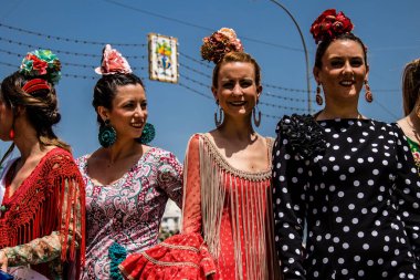 Seville, Spain - May 01, 2022 Sevillians dressed in traditional Andalusian way strolling the aisles of the Feria de Seville, This celebration is back after two years of absence due to covid epidemic