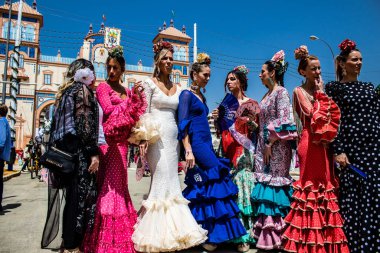 Seville, Spain - May 01, 2022 Sevillians dressed in traditional Andalusian way strolling the aisles of the Feria de Seville, This celebration is back after two years of absence due to covid epidemic