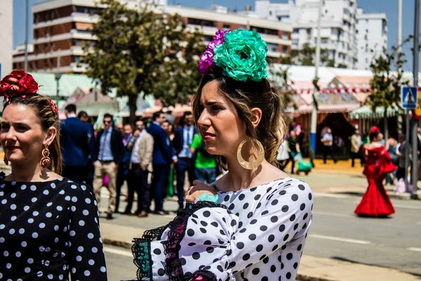 Seville, İspanya - 1 Mayıs 2022 Sevilla 'lılar geleneksel Endülüs tarzında giyinmiş Feria de Seville koridorlarında dolaşıyorlar.
