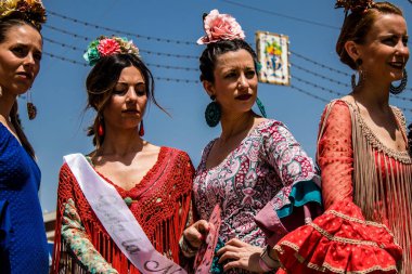 Seville, Spain - May 01, 2022 Sevillians dressed in traditional Andalusian way strolling the aisles of the Feria de Seville, This celebration is back after two years of absence due to covid epidemic