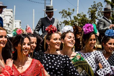 Seville, Spain - May 01, 2022 Sevillians dressed in traditional Andalusian way strolling the aisles of the Feria de Seville, This celebration is back after two years of absence due to covid epidemic