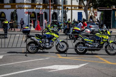 Seville, Spain - May 01, 2022 Police officer in the streets during Feria de Sevilla, the most famous festival in Spain, This celebration is back after two years of absence due to covid pandemic