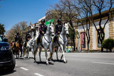 Seville, Spain - May 01, 2022 Police with horse in the streets during Feria de Sevilla, the most famous festival in Spain, This celebration is back after two years of absence due to covid pandemic