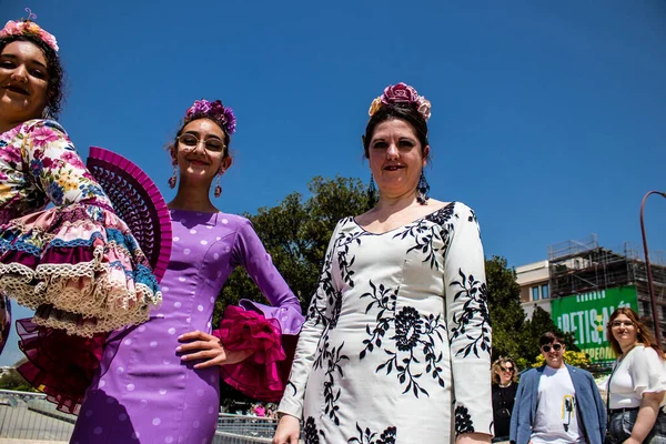 Seville, İspanya - 01 Mayıs 2022 Sevilla sokaklarında yürüyen geleneksel Endülüs tarzı giyinmiş Sevilla halkı iki yıl süren şiddetli bir salgından sonra geri döndü.