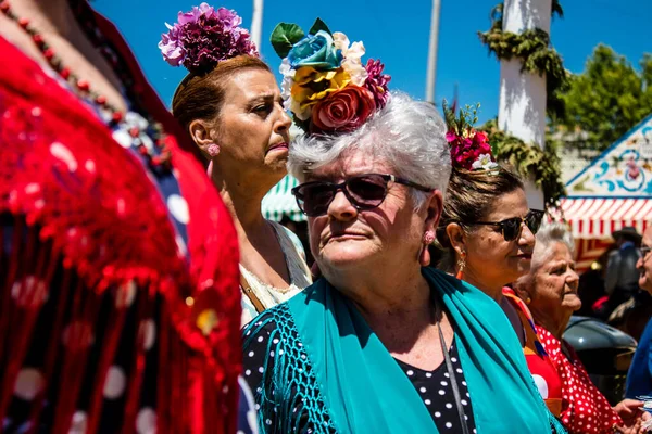 stock image Seville, Spain - May 05, 2022 Sevillians dressed in traditional Andalusian way strolling the aisles of the Feria de Seville, This celebration is back after two years of absence due to covid epidemic